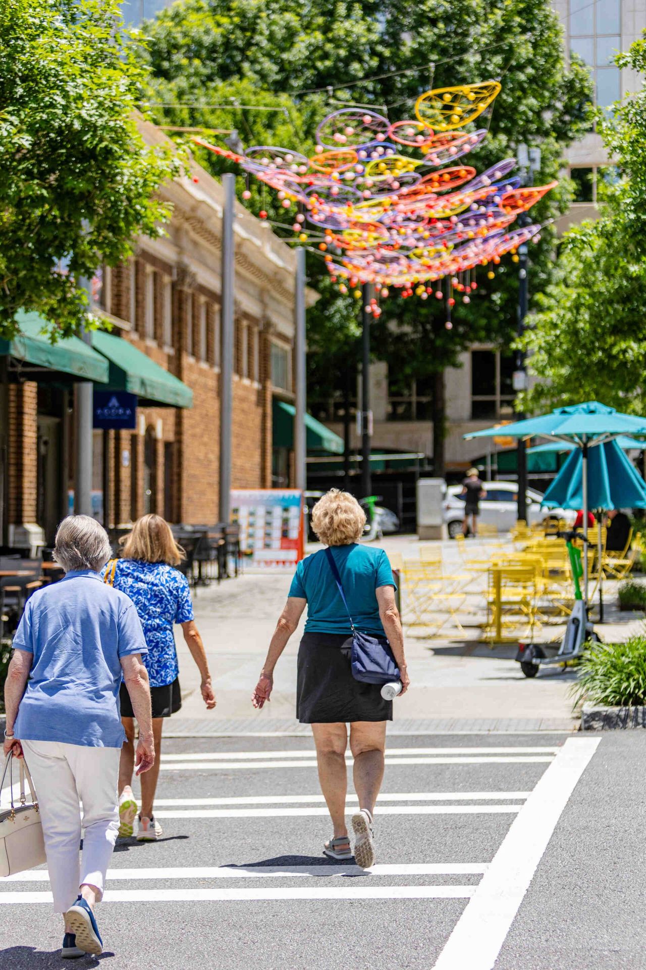 Street near Emmi Midtown featuring people walking